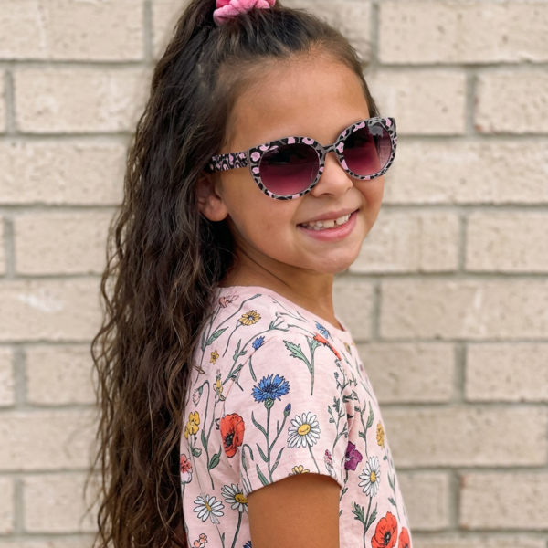 girl with flower shirt and cheeta print kids sunglasses
