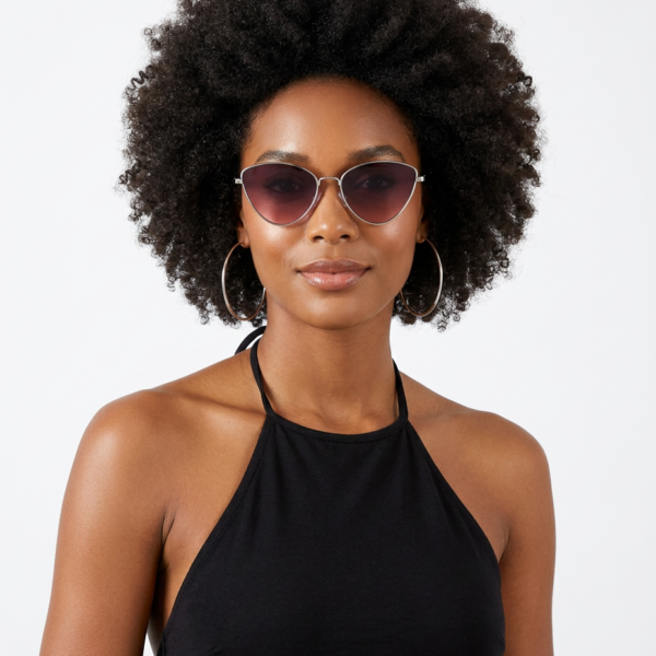 Woman with an Afro hairstyle wearing cat-eye sunglasses, large hoop earrings, and a black halter top, posing against a light background.